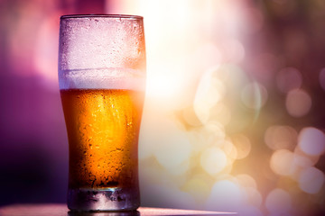 Beer in glass with sun ray background