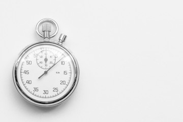 Ancient mechanical stopwatch on a gray background.