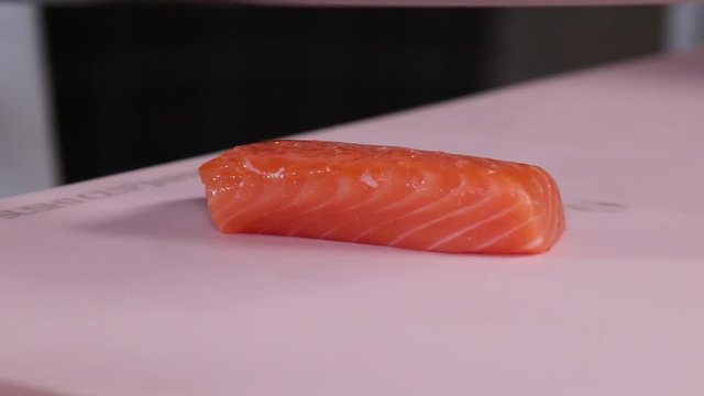 Cutting georgeous red fish fillet into neat slices