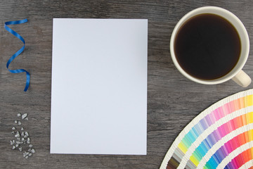 Obraz na płótnie Canvas Top view of empty white page and color range cards with coffee cup