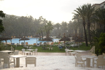 Fototapeta premium View of heavy rains in backyard with pool