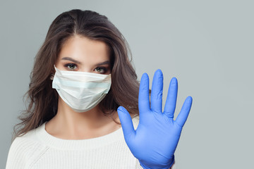 Doctor, nurse or scientist woman  in protective mask showing stop gesture