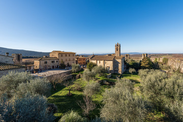 Fototapeta na wymiar Medieval village of Monteriggioni. Church of Santa Maria Assunta (XIII century) and surrounding wall. Siena province, Tuscany, Italy, Europe