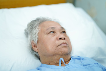 Asian senior or elderly old lady woman patient smile bright face with strong health while lying on bed in nursing hospital ward : healthy strong medical concept