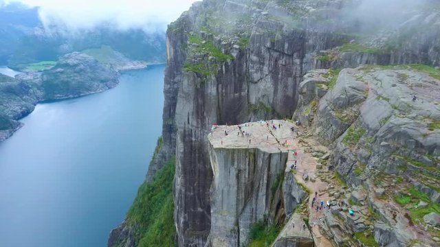 Aerial drone flight over Pulpit Rock a.k.a. Preacher&rsquo;s Chair. The famous tourist place Preikestolen in the mountains of Norway. Taken in summer in foggy weather