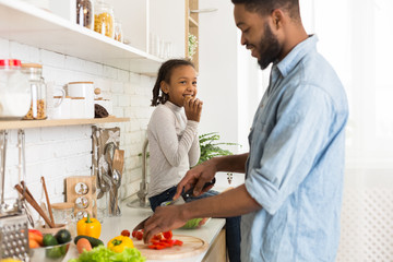 Father and daughter preparing healthy food together at home