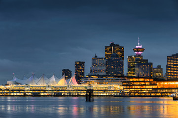 Fototapeta na wymiar Modern buildings illumination with central market on coastline at Stanley park, Vancouver