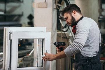 Aluminium and PVC industry worker making PVC or aluminium frames for windows and doors