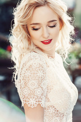 Portrait of Beautiful Happy Curly Blond Hair Bride. Fashion Dress and MakeUp with Red Lips