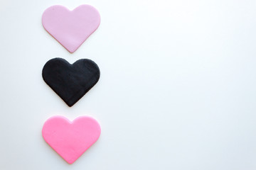 Three multi-colored hearts on a white background