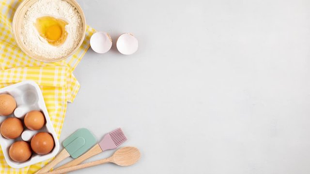 Baking utensils and cooking ingredients for tarts, dough and pastry. Flat lay with eggs, flour, tomatoes, herbs. Top view, mockup for recipe, culinary classes, cooking blog. Stop motion animation