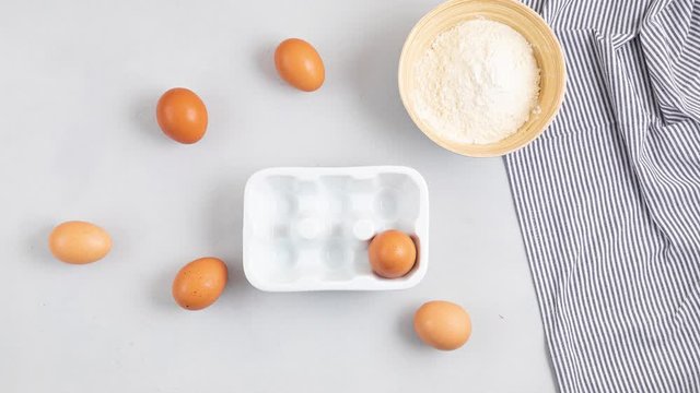 Baking utensils and cooking ingredients for tarts, cookies, dough and pastry. Flat lay with eggs, flour, berries.Top view, mockup for recipe, culinary classes, cooking blog. Stop motion animation
