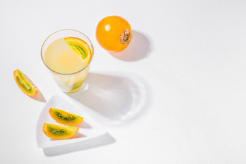 glass with juice and slices of lulo fruit, on the table