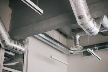 Large ventilation pipes indoors metal aluminum