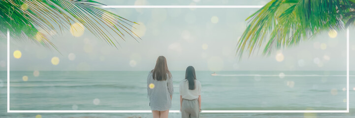Fototapeta premium abstract blur web banner summer background from two woman stand see to beach and blue sea with coconut leaf on sunny day