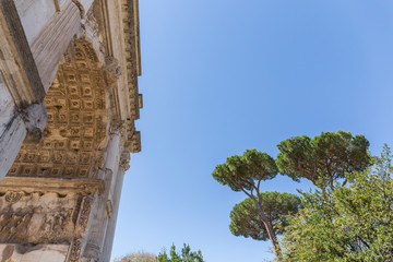 part of a Roman building made of stone, arch seen from below with different engravings in the...