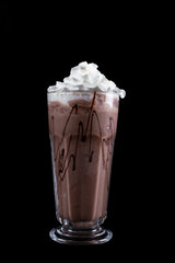 Chocolate Milk and Whipped Cream on black Background. Chocolate cocktail. Chocolate milk shake with whipped cream isolated on black background