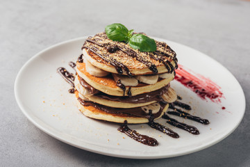 american pancakes with bananas and chocolate cream