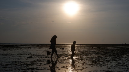 silhouette of a women walking on the beach