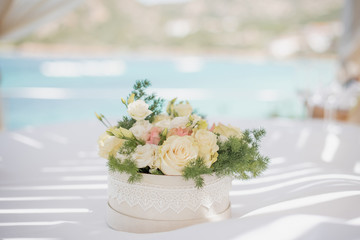 Wedding flowers composition on the table by the sea