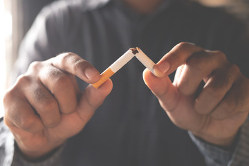 Man refusing cigarettes concept for quitting smoking and healthy lifestyle dark  background. or No...
