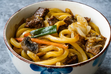 Asian Style Japanese Udon Noodle Soup with Beef, Mushroom and Vegetables. Close Up Macro View.