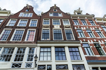 Fototapeta premium Old traditional leaning houses in Amsterdam, Netherlands
