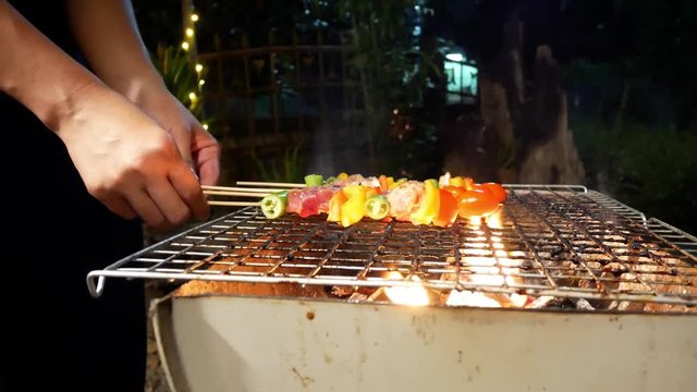 Barbecue Spicy fire on the  flaming grill.Grilled vegetable,pork and chicken skewers with bell peppers.Dinner party barbecue and roast pork at night.winter season BBQ outdoors in garden at home