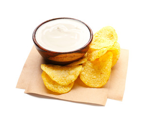 Bowl with tasty sour cream and potato chips on white background