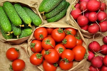 Fototapeta na wymiar Fresh vegetables from farmers market. Cucumbers, tomatoes, radish. Pickle cucumbers. Organic vegetables. Salad ingredients.