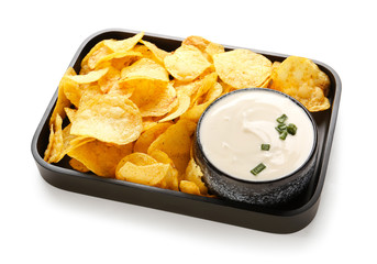 Plate with tasty sour cream and potato chips on white background