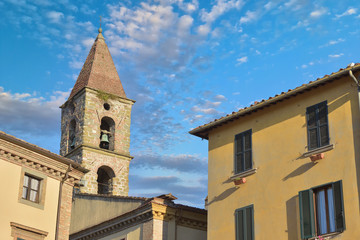 Fototapeta na wymiar Close-up of colorful traditional italian buildings, bell tower and rooftops in a blue sunny day.
