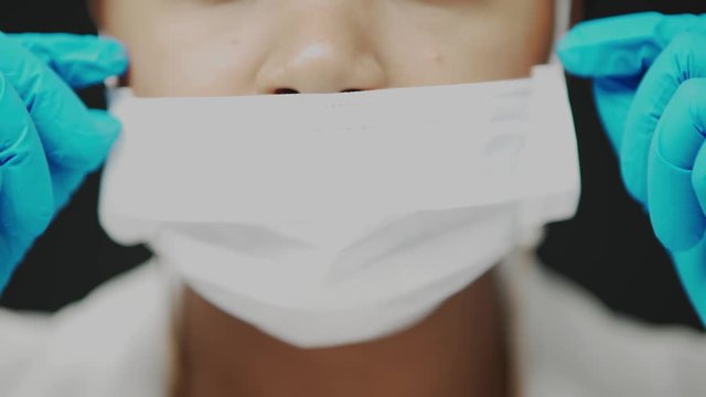 Close up Black woman wearing surgical mask wrong way which just covers her mouth, not preventing the virus spreading during the pandemic Coronavirus Covid-19, virus infection, healthcare and medical.