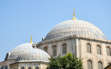 Fototapeta na wymiar Outer view of Large dome and two semi-domes with finials in Ottoman architecture , against blue sky, copy space Istanbul, Turkey