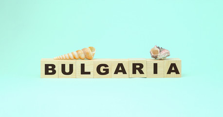 Bulgaria word on wooden blocks with sea shels around tourism and travel concept