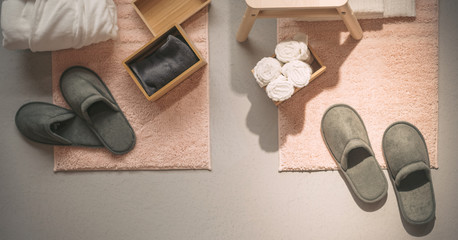 bathrobe towel and slippers set of personal items in hotel room travel concept