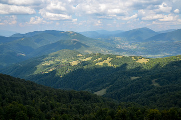 Obraz na płótnie Canvas Panoramic view of picturesque Carpathian Mountains landscape with forest slopes, mountain ranges and peaks. Holidays in the mountains.