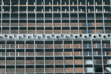 Fototapeta na wymiar Lattice metal stairs. A fragment of a metal staircase structure