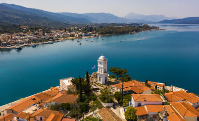 Aerial drone bird's eye view photo of the clock tower of Poros island, Greece