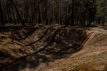 A large hole in the form of a ditch in the forest where SUVs and motorcycles ride | VERKHNYAYA PYSHMA, RUSSIA - 04 MAY 2020.