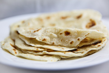Classic Mexican flour tortilla on white plate