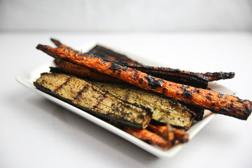 Grilled vegetables on white plate with carrots and zucchini 