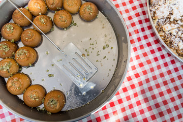 Lokma, Turkish street food dessert. Bites flavoured with honey, sugar syrup