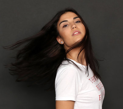 Beautiful caucasian hipster brunette girl posing in studio on isolated background. Trends, style, good time, fashion concept.