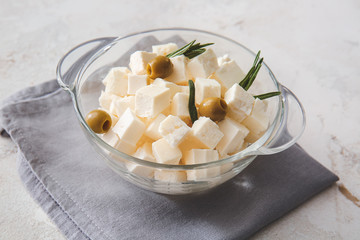 Bowl with tasty cut feta cheese on table