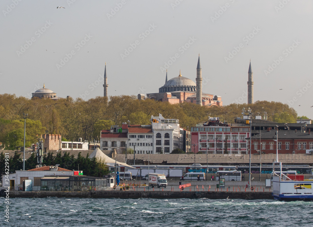 Wall mural Istanbul, Turkey - a natural separation between Europe and Asia, the Bosporus is a main landmark in Istanbul. Here in particular a glimps of its waters and buildings