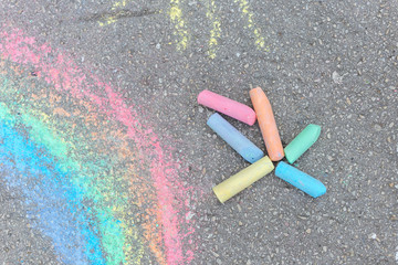 Colored chalk on playground with drawings on the street.
