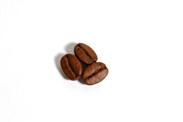 Roasted coffee beans isolated on a white background. Brown coffee beans Robusta chocolate shade