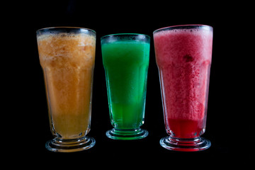 Frozen fresh fruits drinks. Fresh fruits, juice drinks isolated on black background. iced drink. summer drink