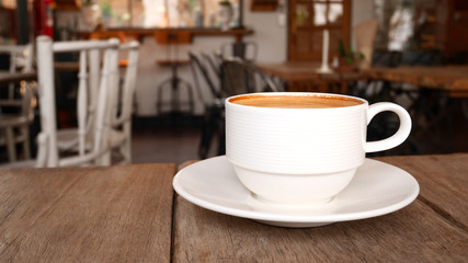 Hot coffee cappuccino latte on wooden background in coffee shop